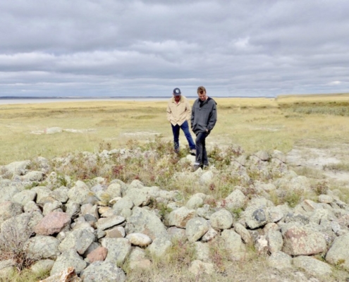 men standing on rocks; native mixed grass prairie